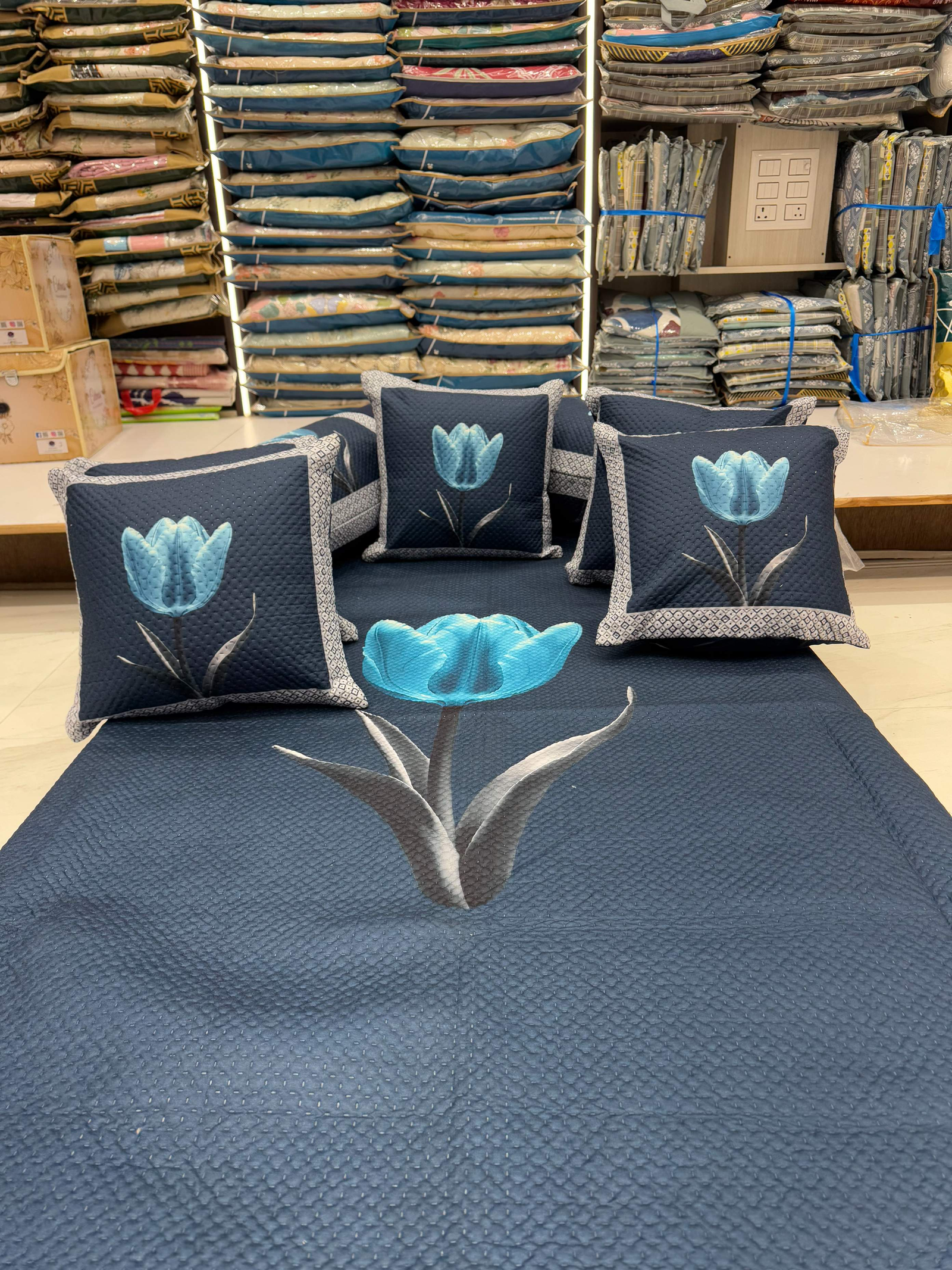 Quilted tulip-print cushions and bed cover